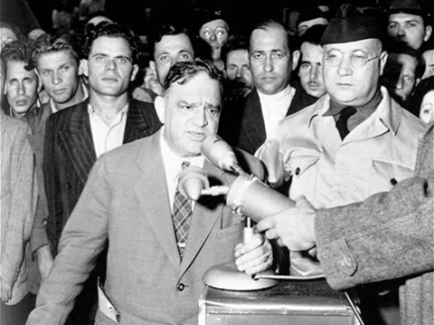 Image of United Nations Relief and Rehabilitation Administration (UNRRA) Director General Fiorello LaGuardia delivers a speech at the Berlin-Schlachtensee displaced persons camp, Berlin, 1946. *United States Holocaust Memorial Museum, courtesy of National Archives and Records Administration, College Park.